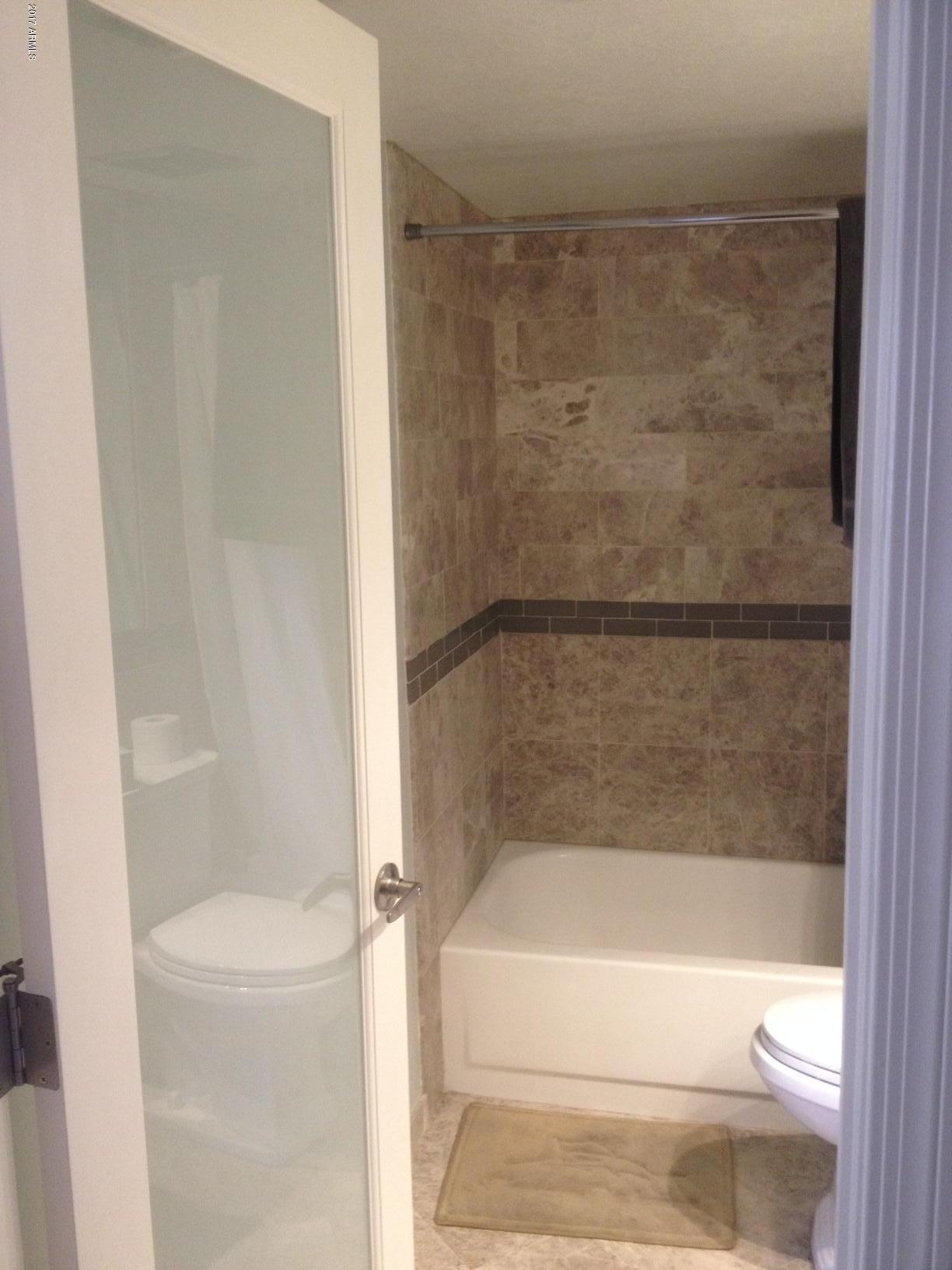 154 West 5th Street, Unit 248 Tempe, AZ 85281 - Photo 11 of 18 a bathroom with a shower and a toilet