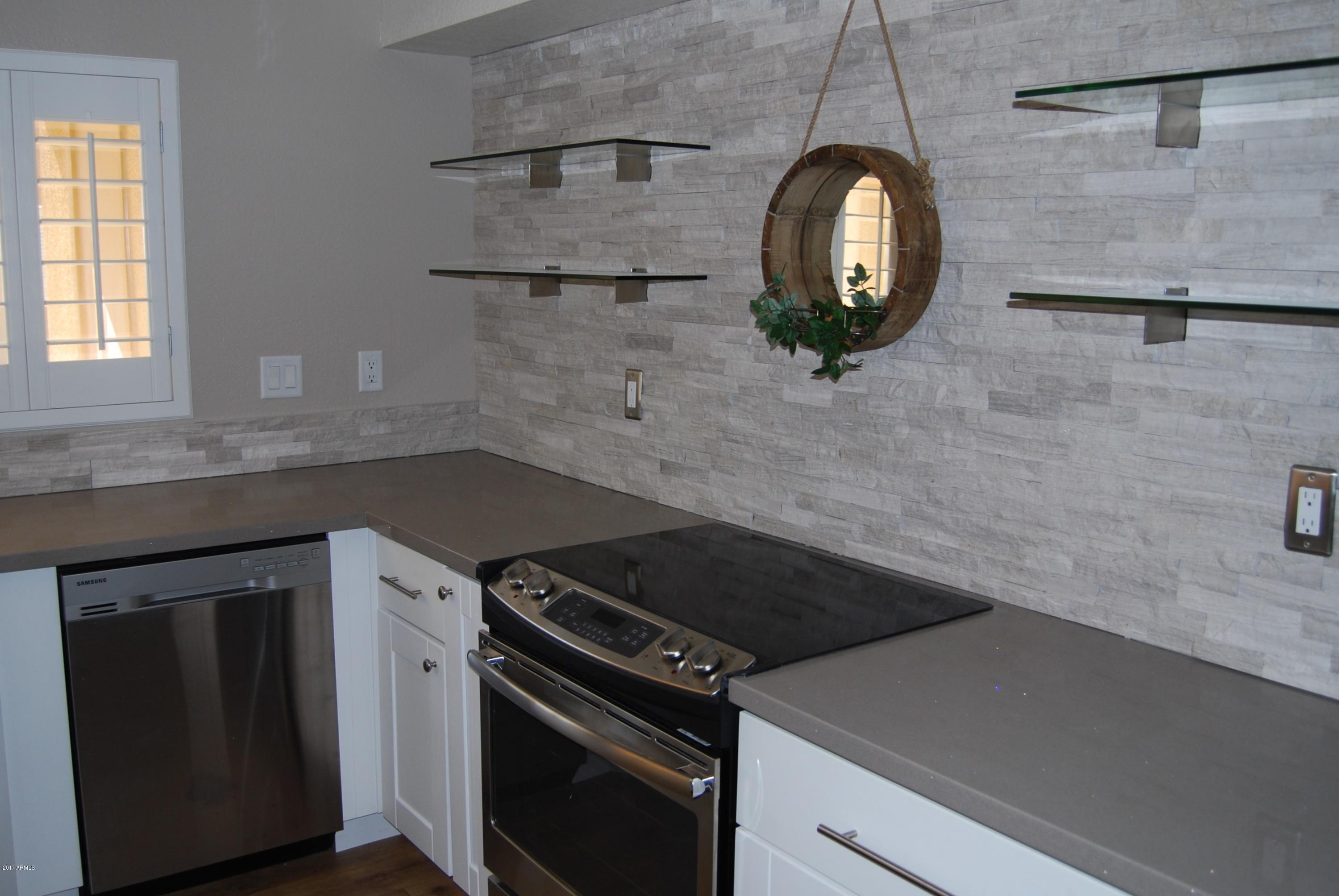 154 West 5th Street, Unit 248 Tempe, AZ 85281 - Photo 2 of 18 a kitchen with a stove and a wooden floor