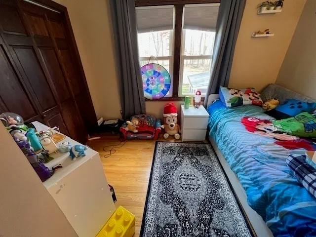 a bed sitting in a bedroom next to a window