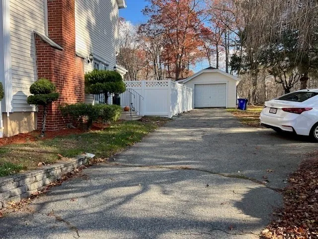 a front view of a house with a garden and parking