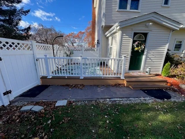 a view of a house with a wooden bench