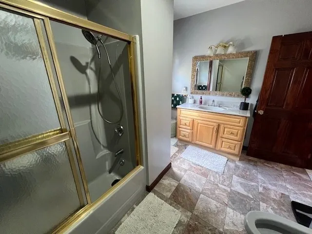 a bathroom with a sink a mirror and a shower