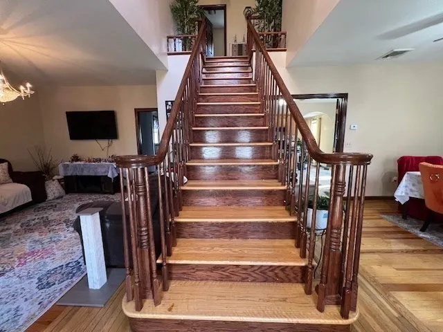 a view of entryway and hall with wooden floor