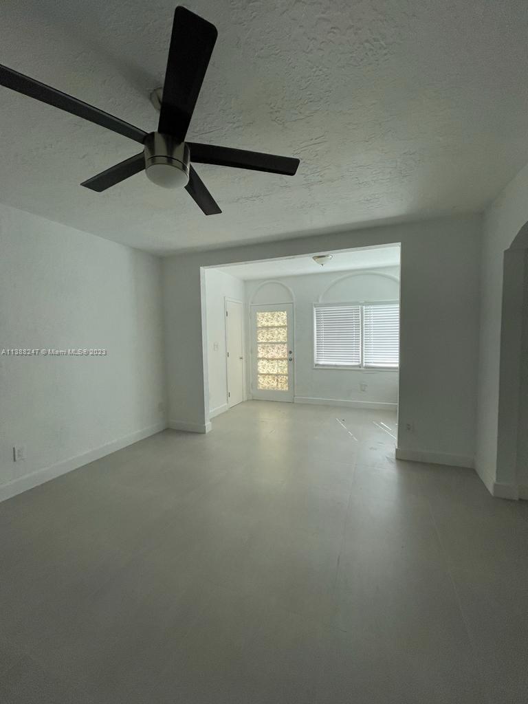 an empty room with a empty space and windows