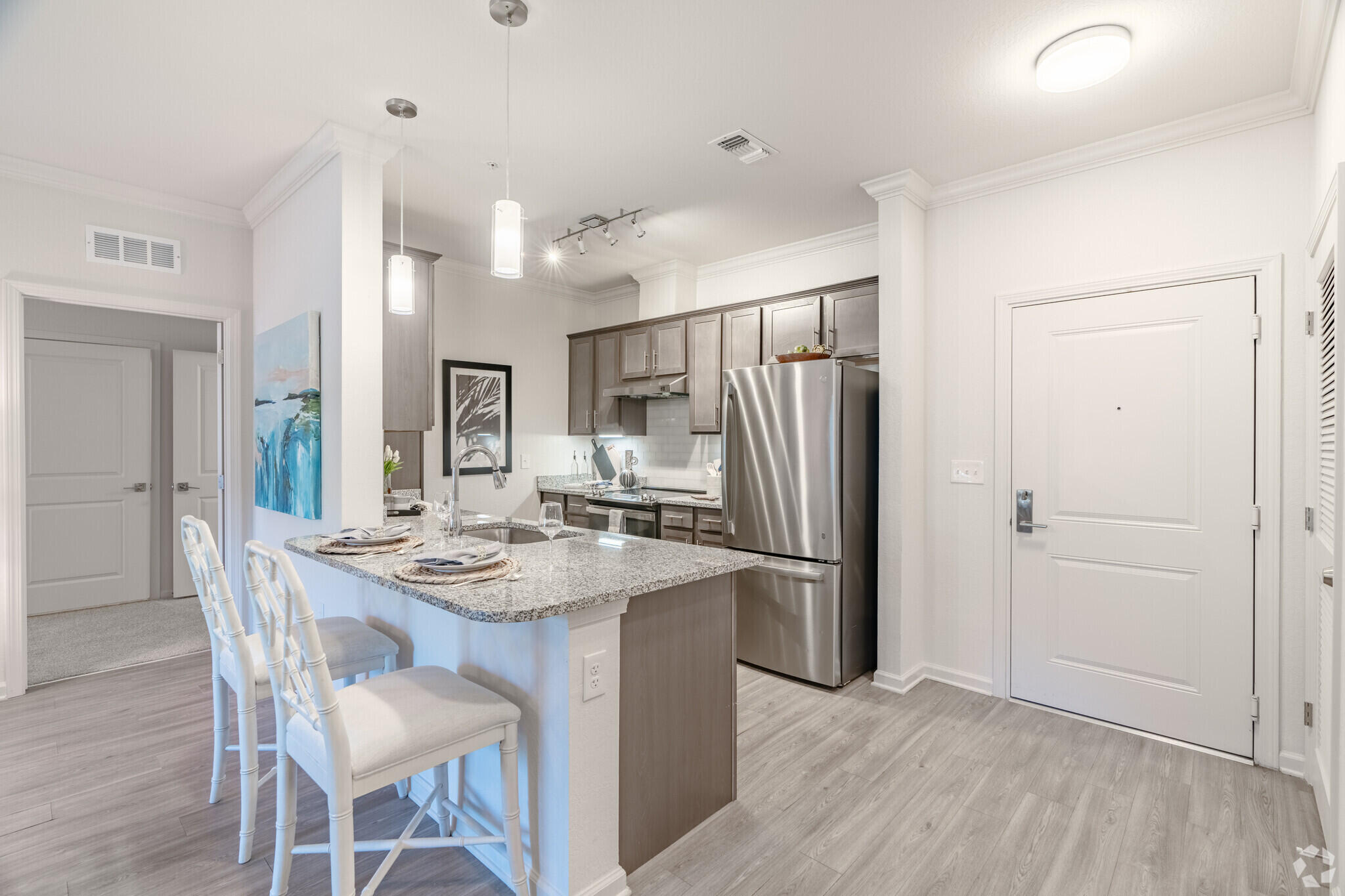 1924 Northwest Federal Highway, Unit 1103 Stuart, FL 34994 - Photo 5 of 19 a kitchen with stainless steel appliances granite countertop a refrigerator and a stove top oven