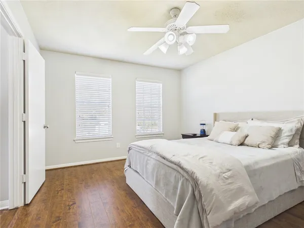 a bedroom with a large bed and a chandelier