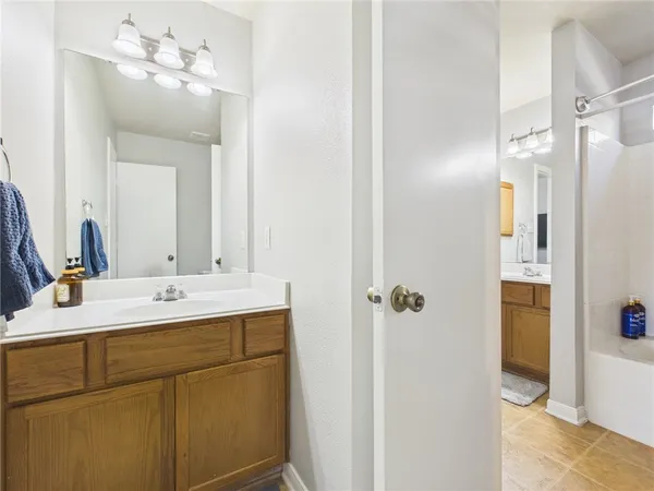 a bathroom with a double vanity sink mirror and shower