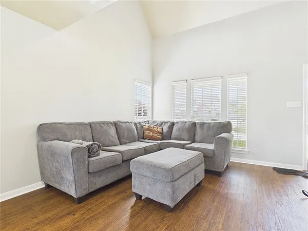 a living room with couches and a coffee table with wooden floor
