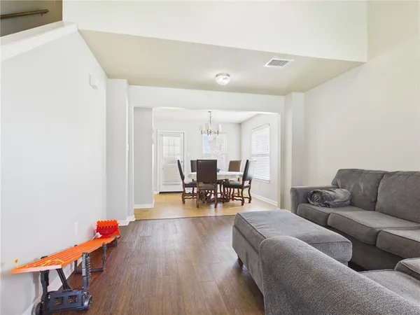 a living room with furniture and wooden floor