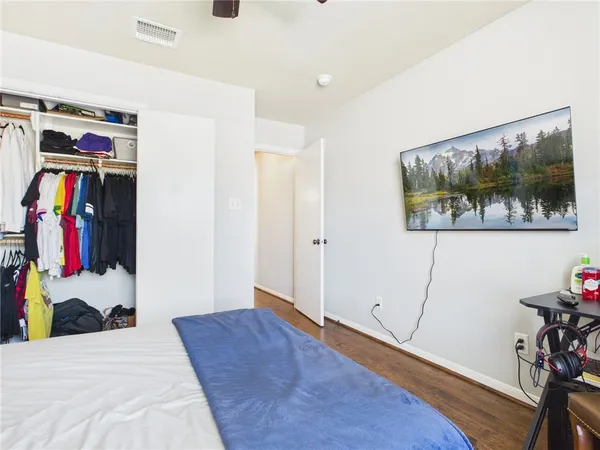 a bed room with a bed and a painting on the wall