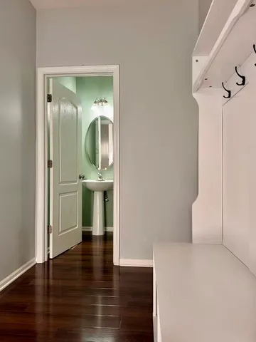 a view of hallway with wooden floor