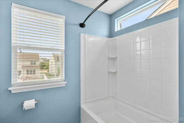 a bathroom with a bathtub and shower