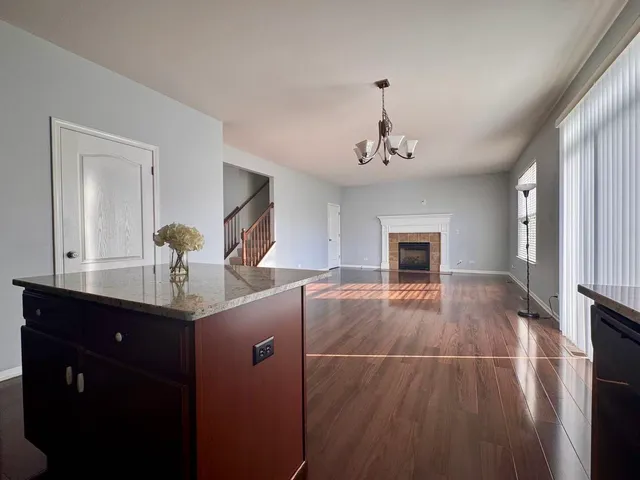 a open kitchen with a refrigerator and a stove