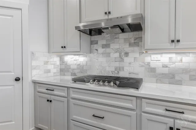 a kitchen with a stove and cabinets