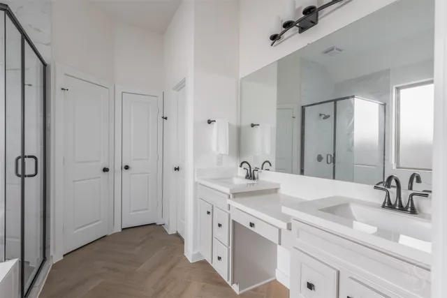 a spacious bathroom with a double vanity sink mirror and