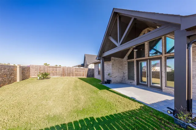 a yellow house with swimming pool in front of it