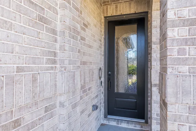 a view of a wooden door with a glass door