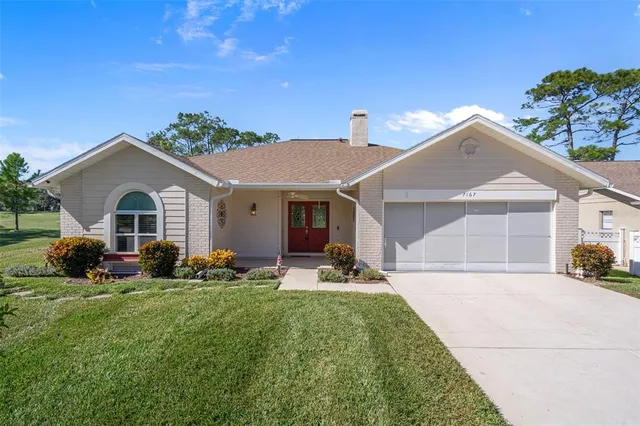 a front view of a house with a yard and porch