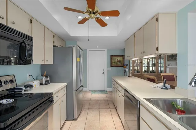 a kitchen with a sink appliances and cabinets