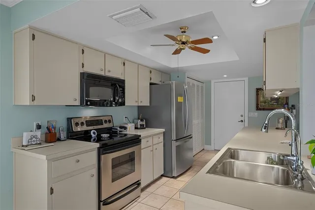 a kitchen with a sink appliances and cabinets