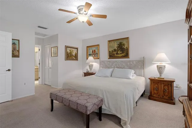 a bedroom with a bed a lamp and a chandelier