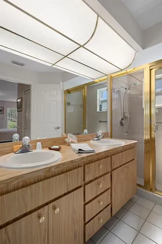 a bathroom with a granite countertop sink mirror and double