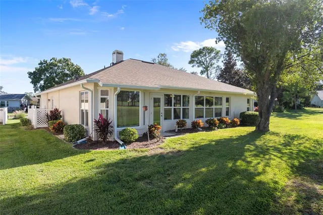 a view of a house with a yard and sitting area