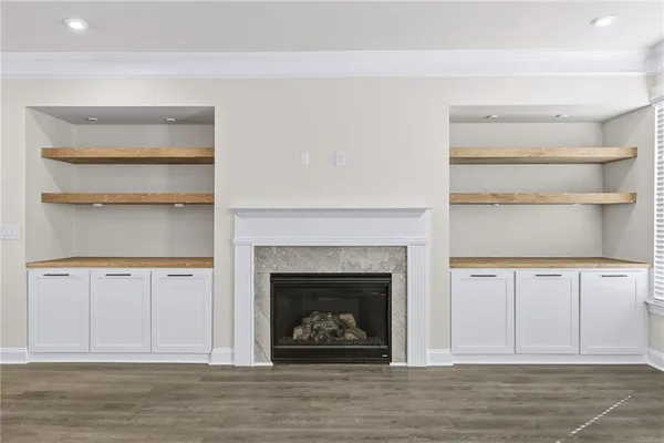 a living room with hard wood floors and a fireplace