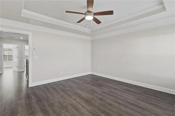 a view of an empty room with wooden floor