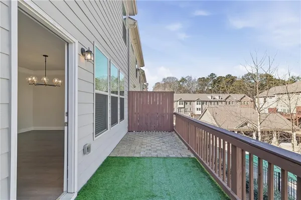 a view of a balcony with wooden floor and fence
