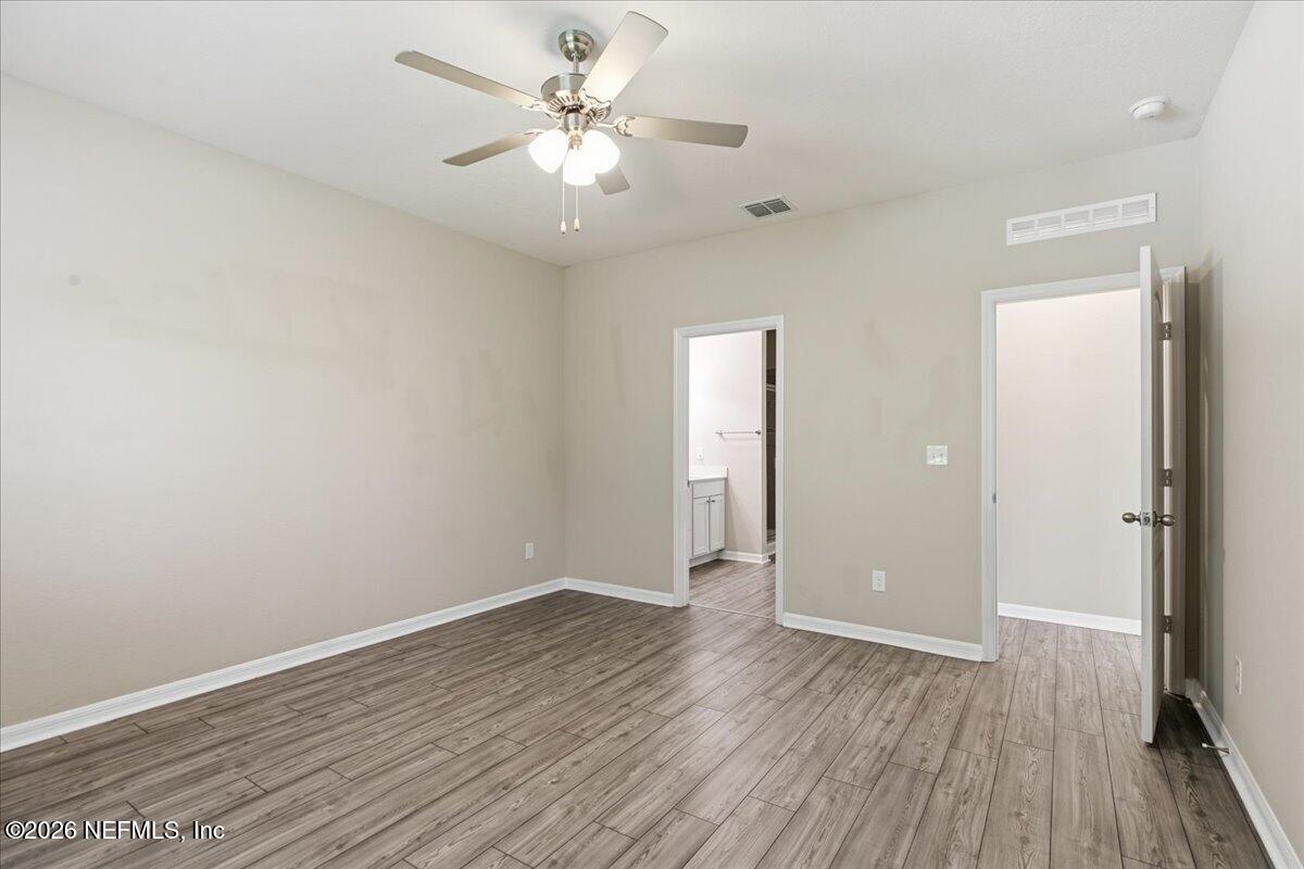 51 Tree Frog Way St. Augustine, FL 32095 - Photo 11 of 21 an empty room with wooden floor and window