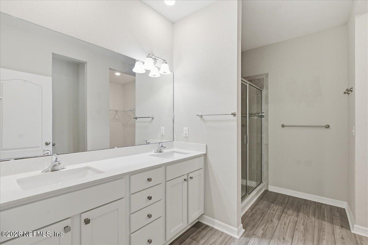 51 Tree Frog Way St. Augustine, FL 32095 - Photo 12 of 21 a bathroom with a double vanity sink and mirror