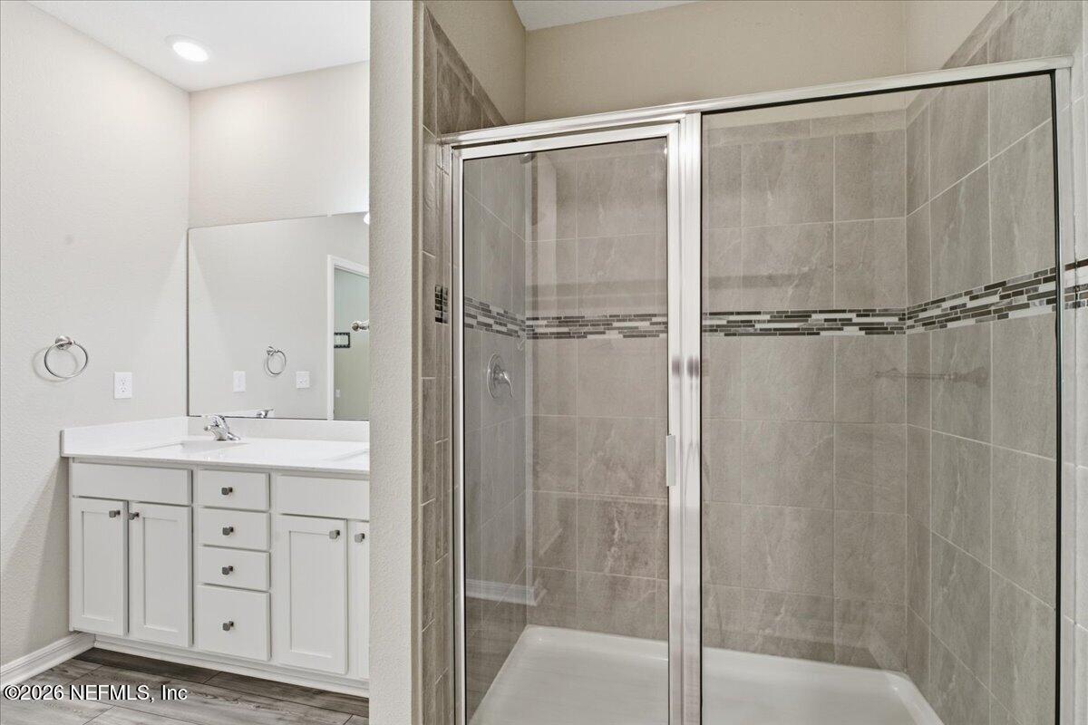 51 Tree Frog Way St. Augustine, FL 32095 - Photo 13 of 21 a bathroom with a shower sink and mirror