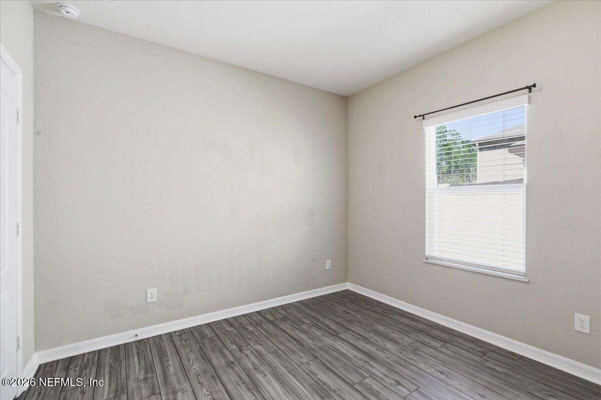 51 Tree Frog Way St. Augustine, FL 32095 - Photo 14 of 21 a view of an empty room with wooden floor and a window