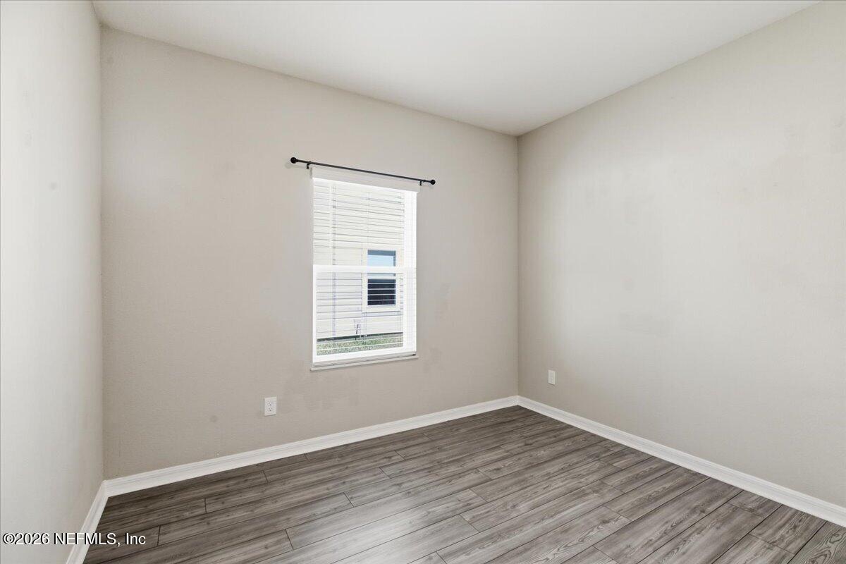 51 Tree Frog Way St. Augustine, FL 32095 - Photo 16 of 21 an empty room with wooden floor and windows