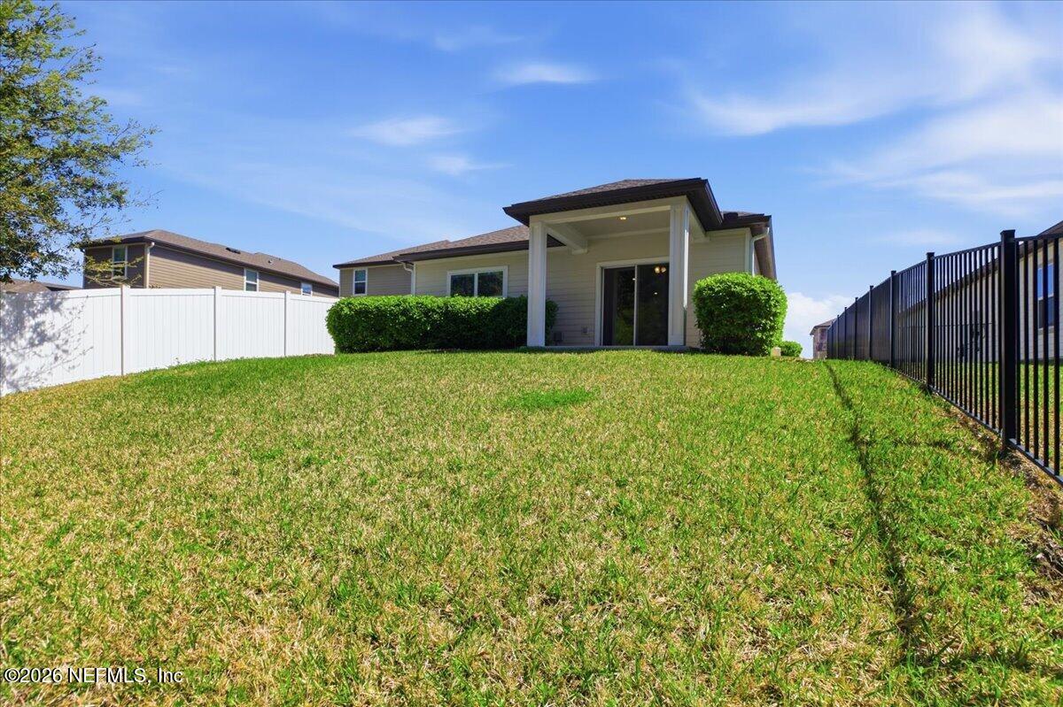 51 Tree Frog Way St. Augustine, FL 32095 - Photo 19 of 21 a view of a house with a big yard and large tree