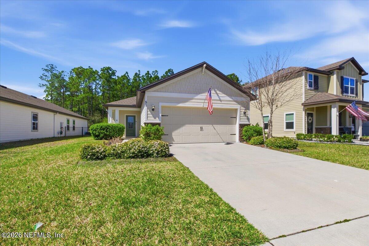 51 Tree Frog Way St. Augustine, FL 32095 - Photo 21 of 21 a front view of a house with a yard and garage