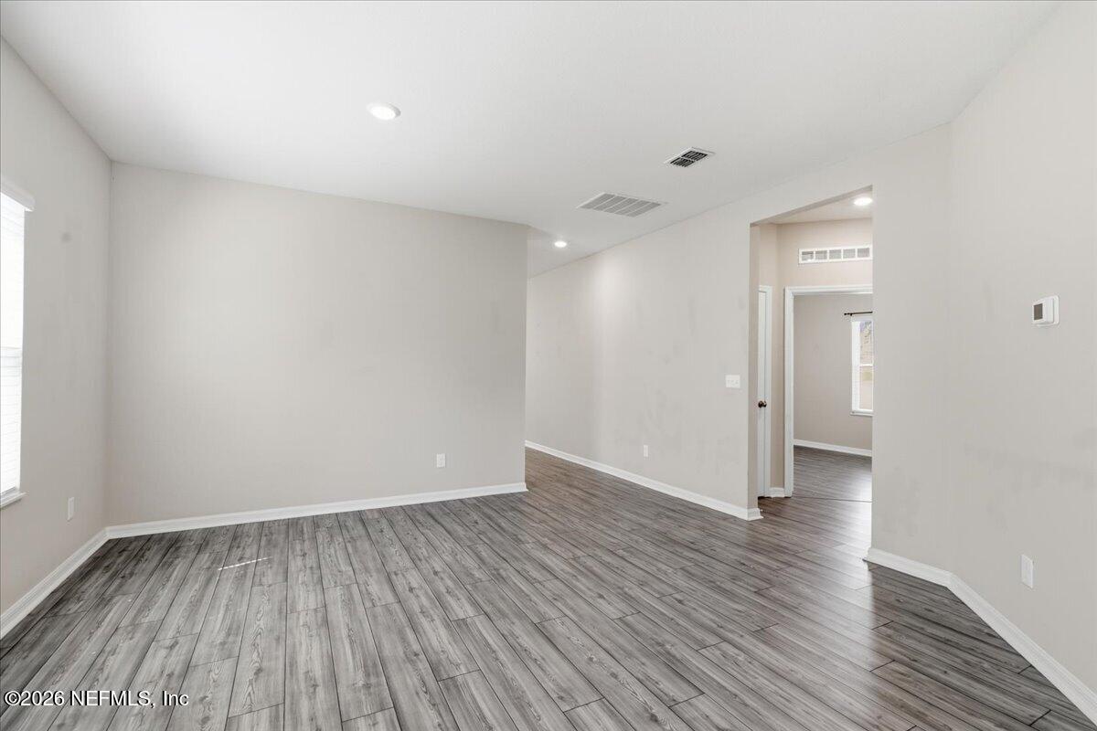 51 Tree Frog Way St. Augustine, FL 32095 - Photo 5 of 21 a view of an empty room with wooden floor and a window