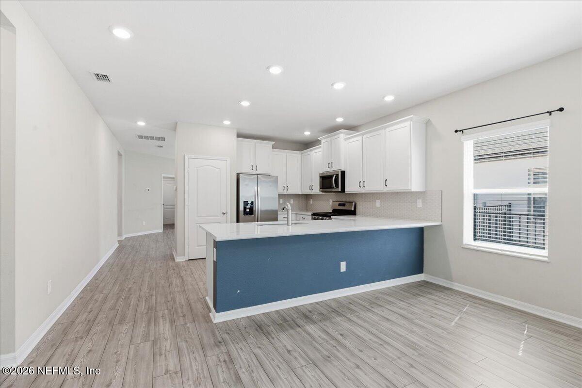 51 Tree Frog Way St. Augustine, FL 32095 - Photo 8 of 21 a view of kitchen with wooden floor