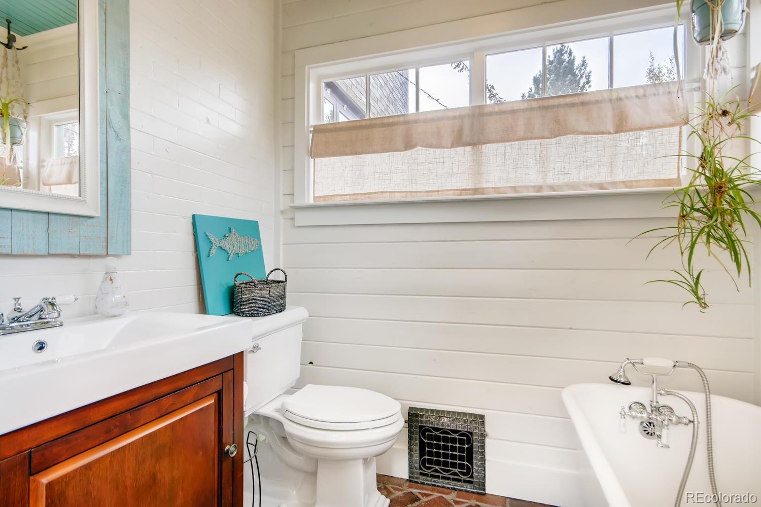 3345 Raleigh Street Denver, CO 80212 - Photo 13 of 27 a bathroom with a sink a toilet and a bathtub