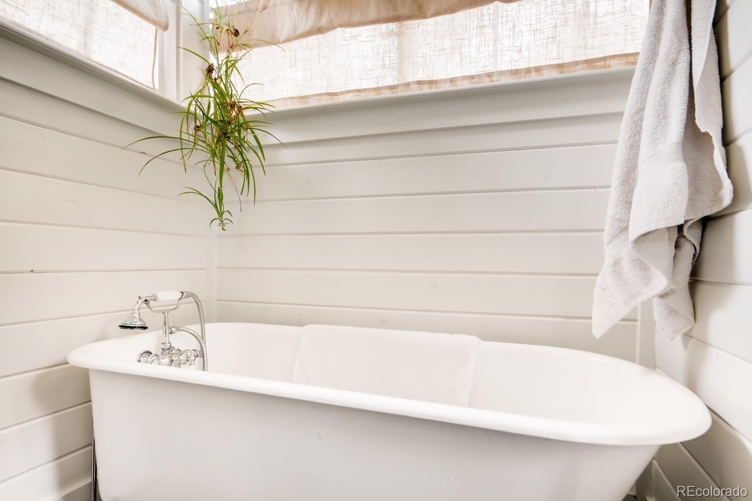 3345 Raleigh Street Denver, CO 80212 - Photo 14 of 27 a bathroom with a bathtub and a sink