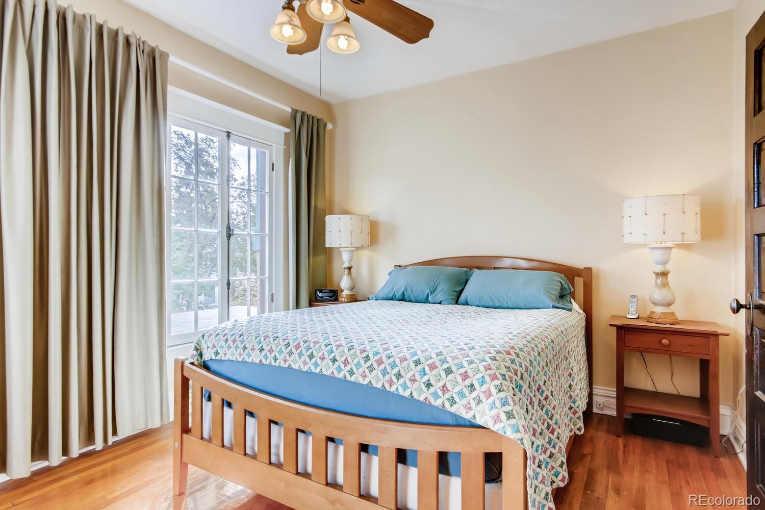 3345 Raleigh Street Denver, CO 80212 - Photo 15 of 27 a bedroom with a bed and a wooden floor