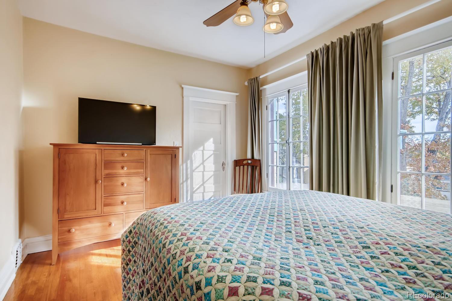 3345 Raleigh Street Denver, CO 80212 - Photo 18 of 27 a bedroom with a bed and a flat screen tv