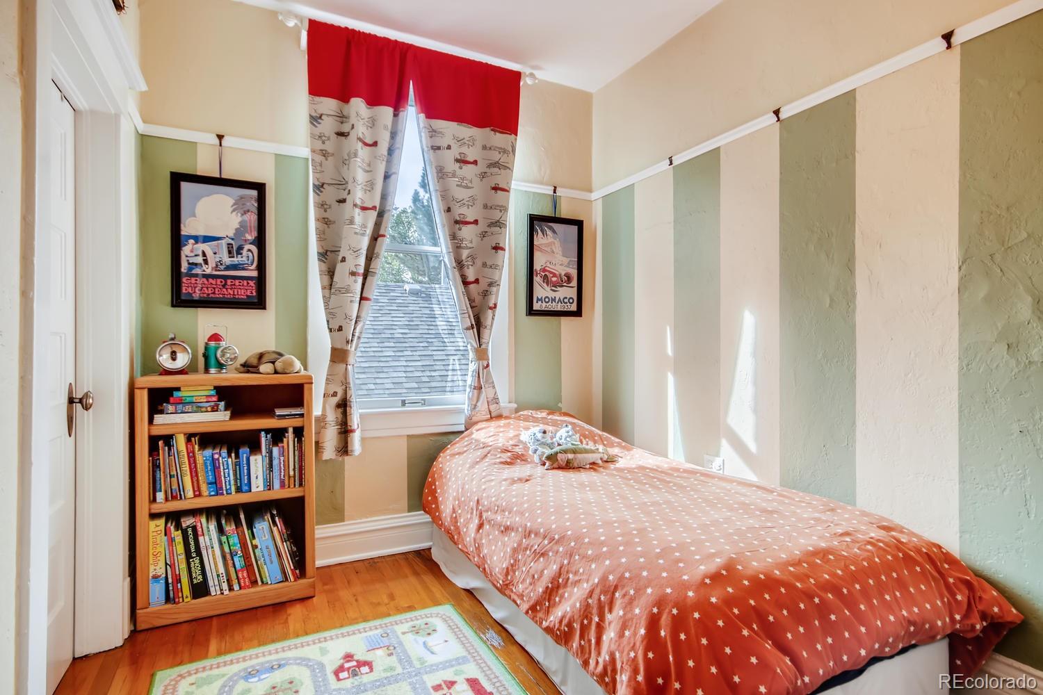 3345 Raleigh Street Denver, CO 80212 - Photo 21 of 27 a bedroom with a bed and a book shelf