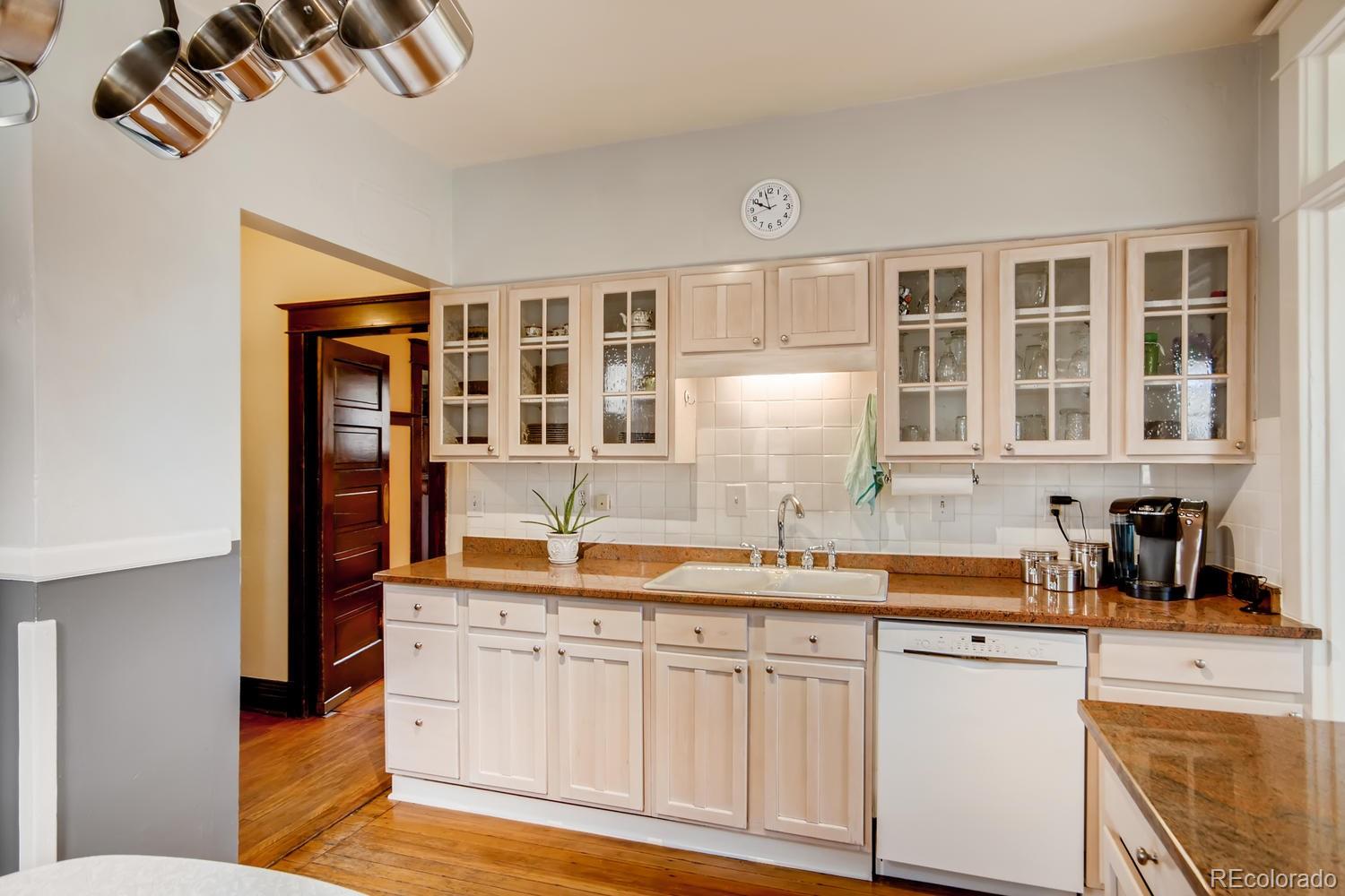 3345 Raleigh Street Denver, CO 80212 - Photo 10 of 27 a kitchen with granite countertop a sink and cabinets