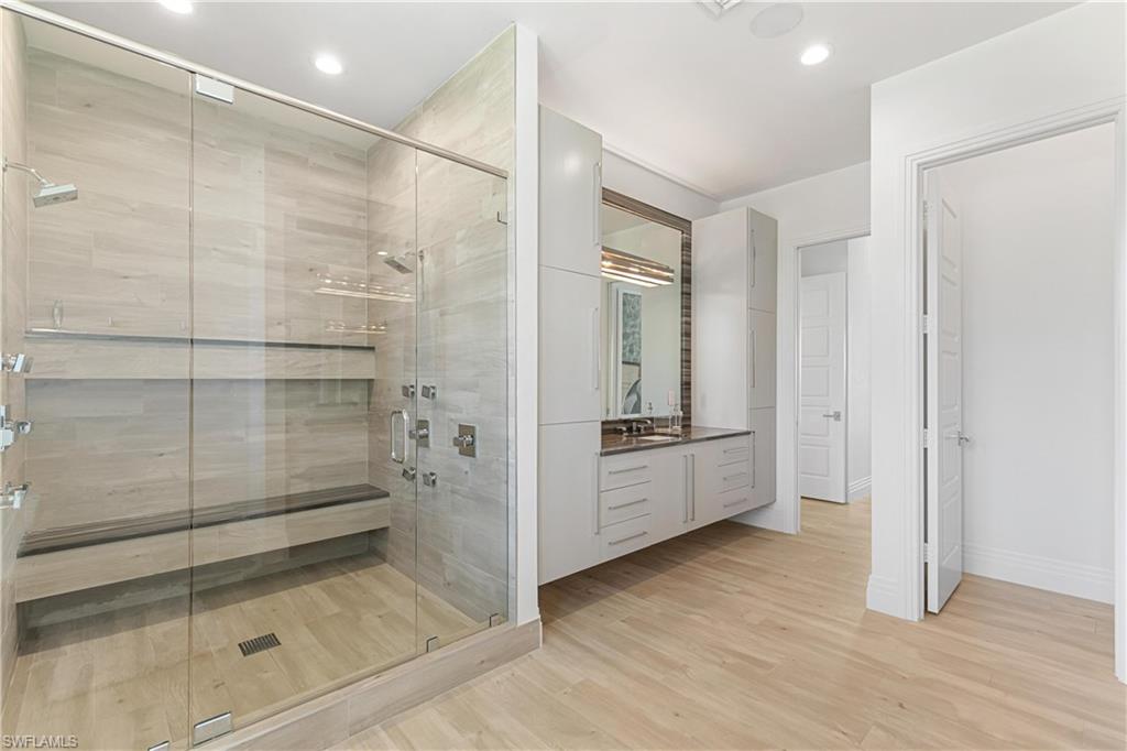 549 Hernando Drive Marco Island, FL 34145 - Photo 11 of 34 a bathroom with a glass door shower a sink and a mirror