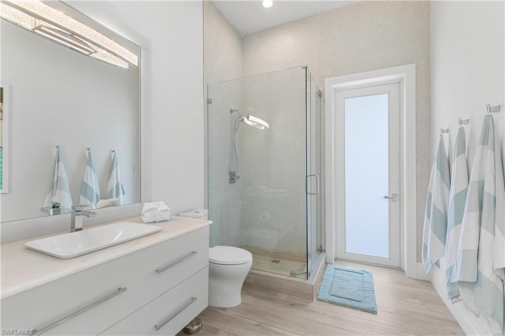 549 Hernando Drive Marco Island, FL 34145 - Photo 13 of 34 a bathroom with a granite countertop sink toilet and shower