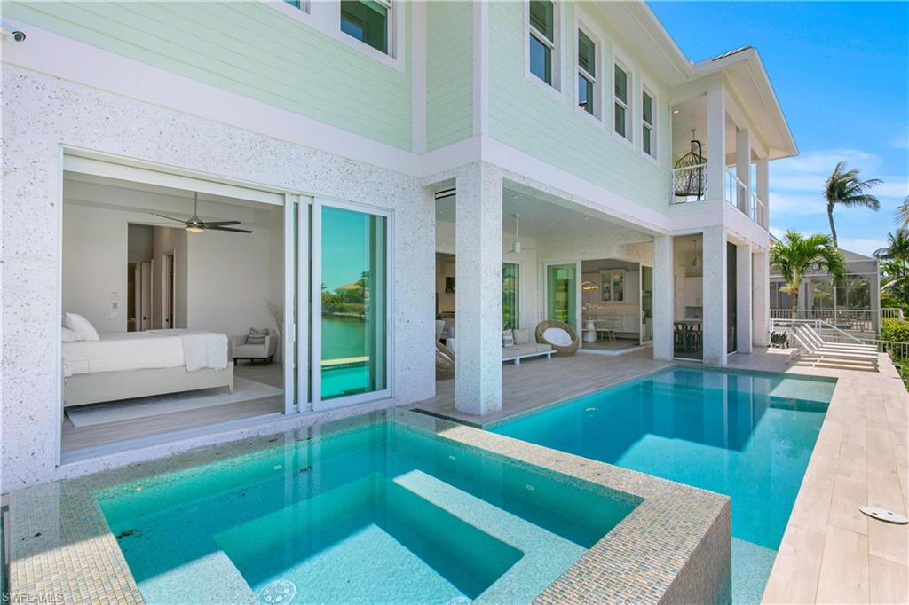 549 Hernando Drive Marco Island, FL 34145 - Photo 17 of 34 a view of an house with swimming pool and porch