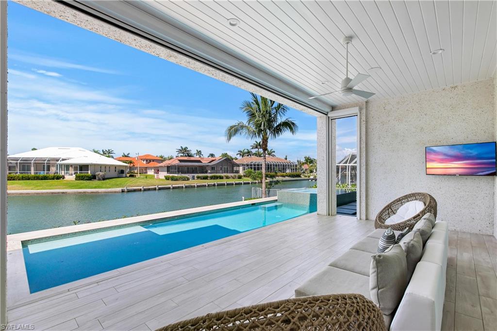 549 Hernando Drive Marco Island, FL 34145 - Photo 18 of 34 a view of swimming pool with seating space and outdoor view