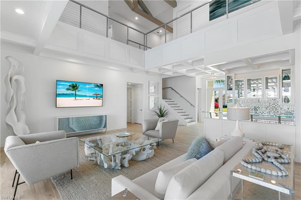 549 Hernando Drive Marco Island, FL 34145 - Photo 6 of 34 a living room with furniture and a chandelier